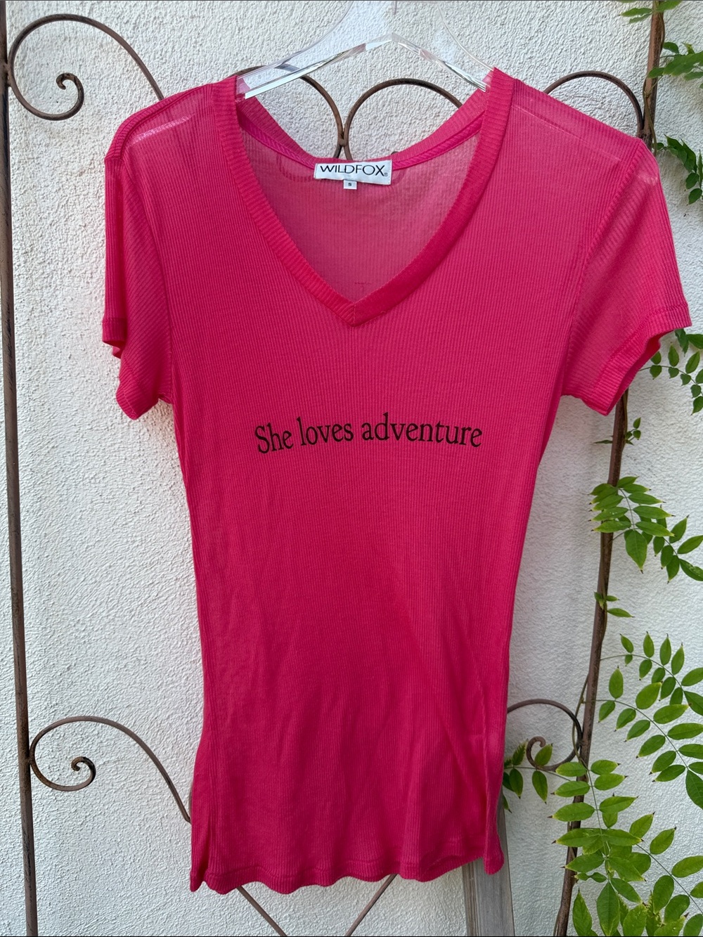 Wildfox Hot Pink V‑Neck Tee with "She loves adventure"